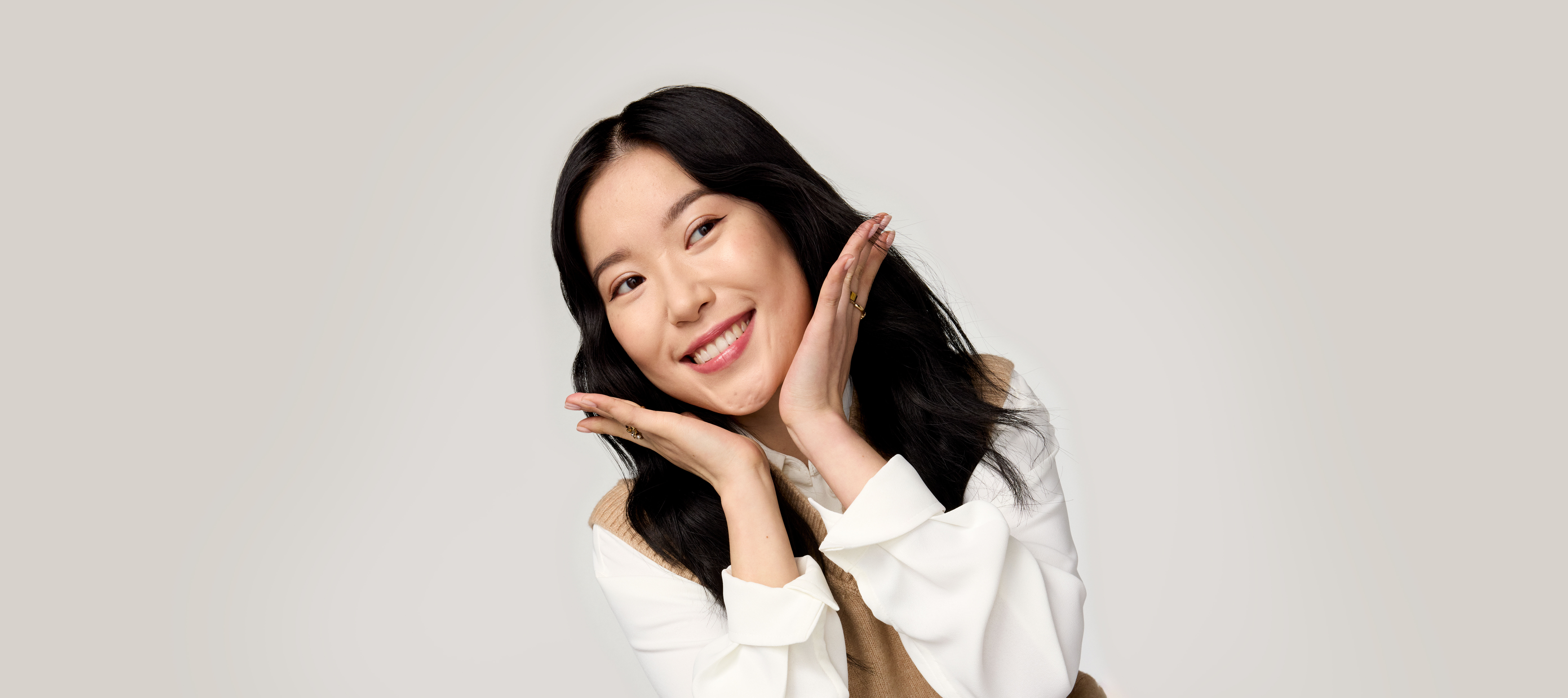 Woman with chin resting on hand wearing Timewise
