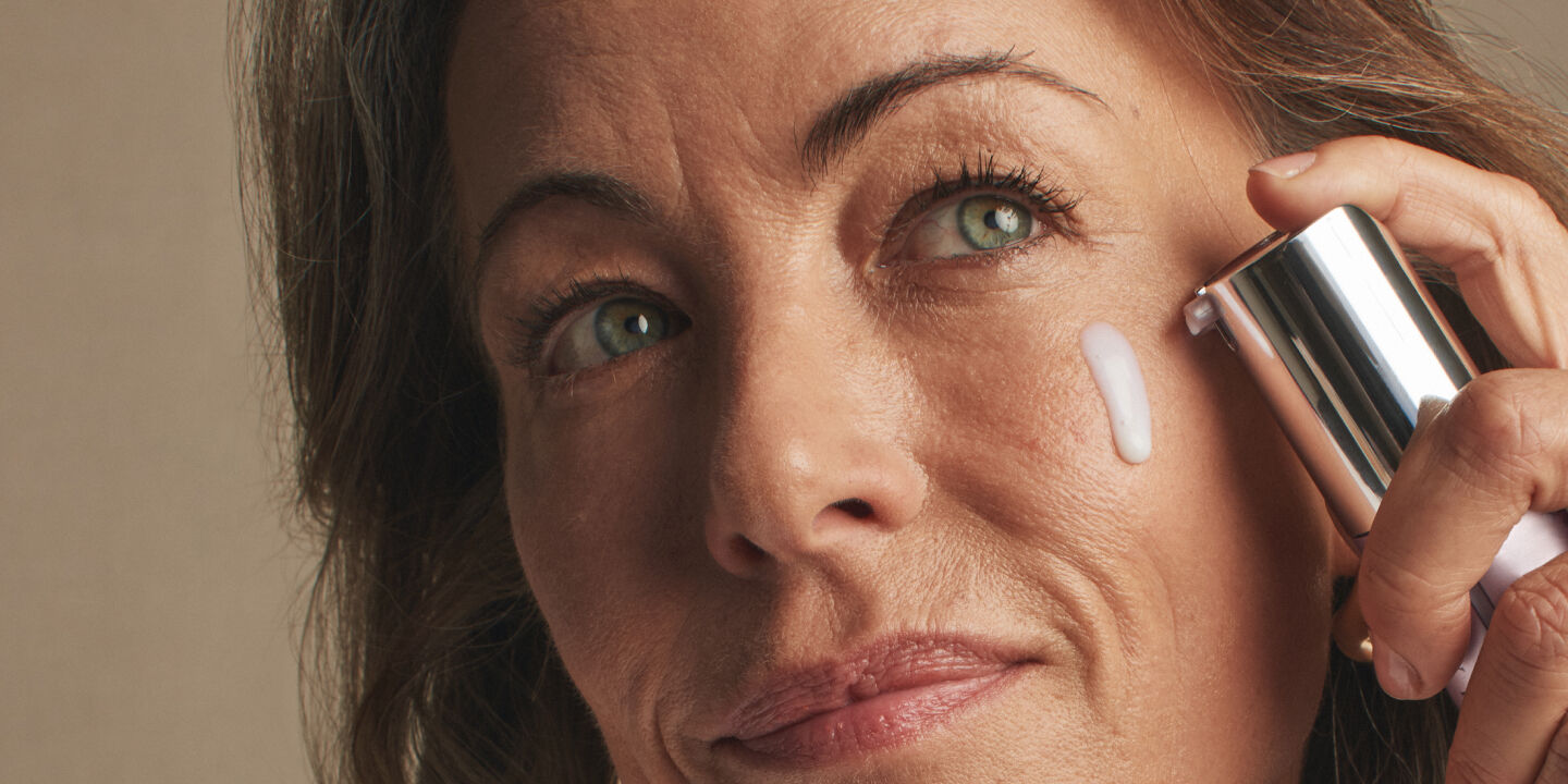 Woman applying Timewise Repair Advanced Lifting Serum