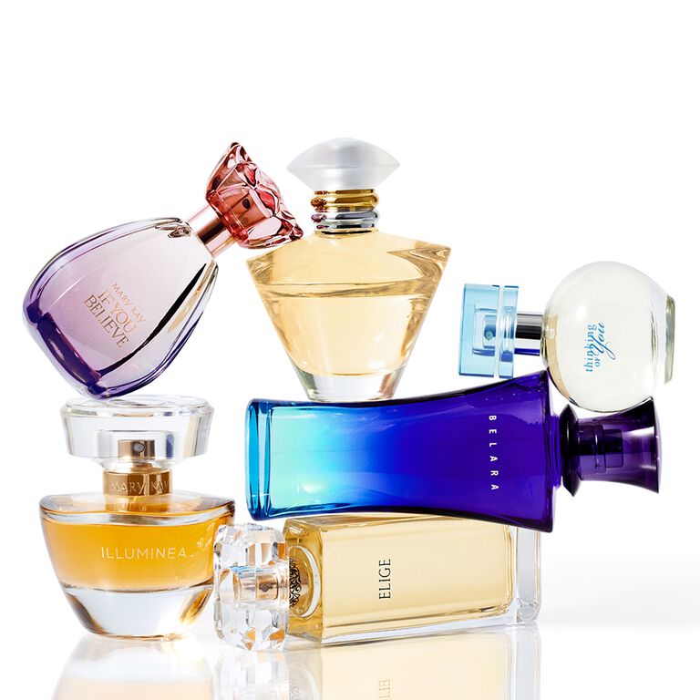 Assorted Mary Kay fragrance bottles in various shapes and colors arranged in a stylish composition.