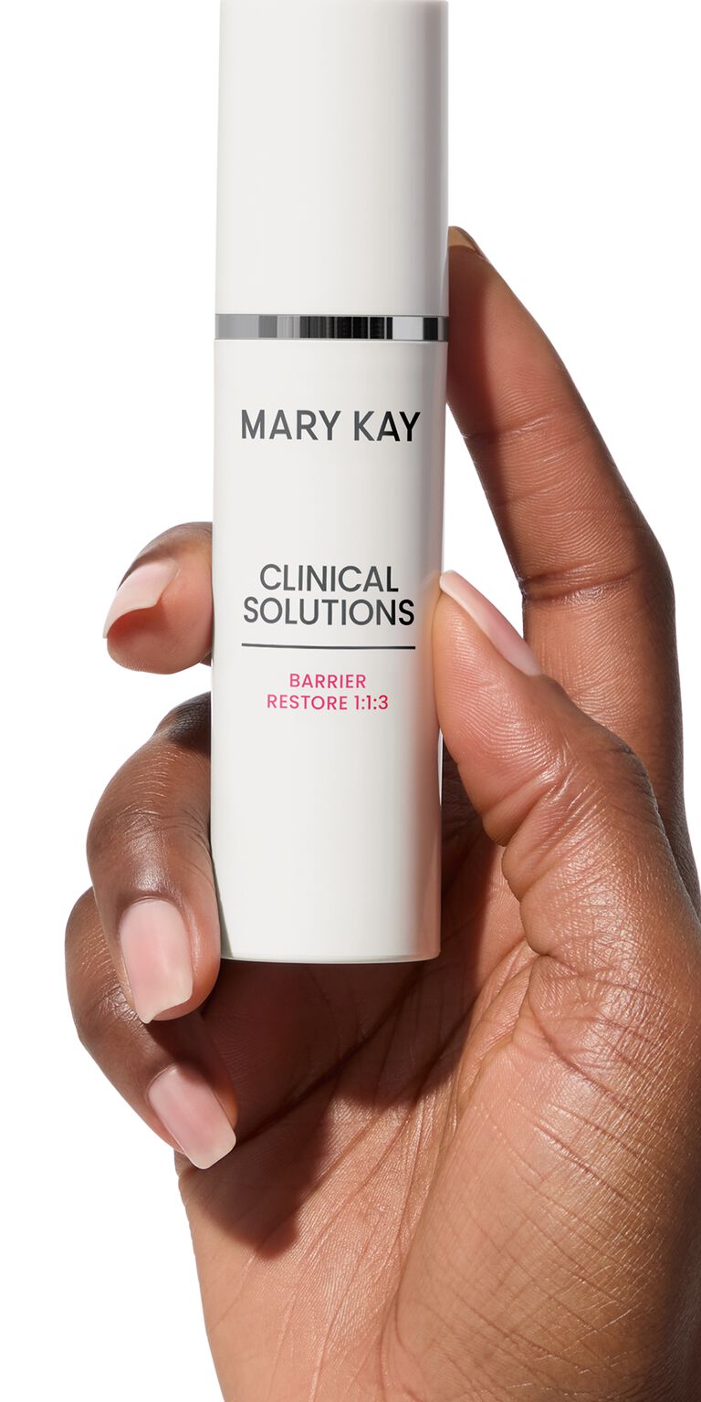 Hand holding bottle of Mary Kay Clinical Solutions Barrier Restore 1:1:3