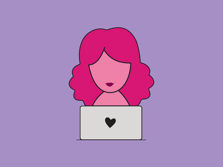 Person working on a laptop with a heart icon on the screen.