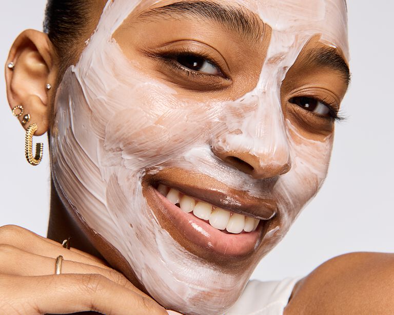 Woman applying thick layer of the Mary Kay Hydration Cream Mask on her face