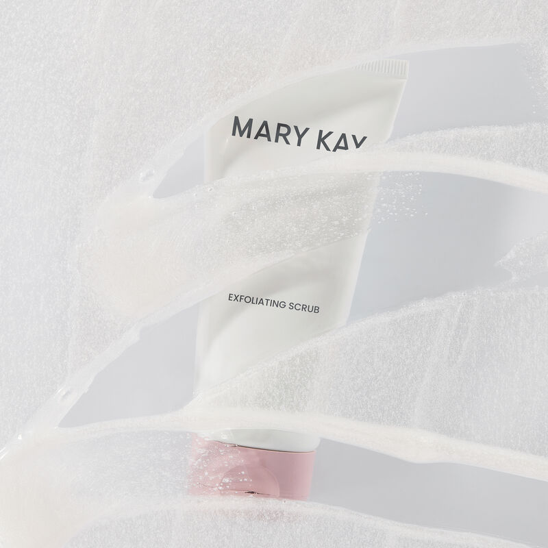 Tube of Mary Kay Exfoliating Scrub behind product rub with transparent swipes