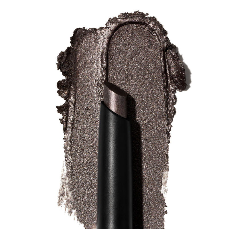 A product rub displays the Midnight Galaxy shade&rsquo;s finish and texture on a white surface.