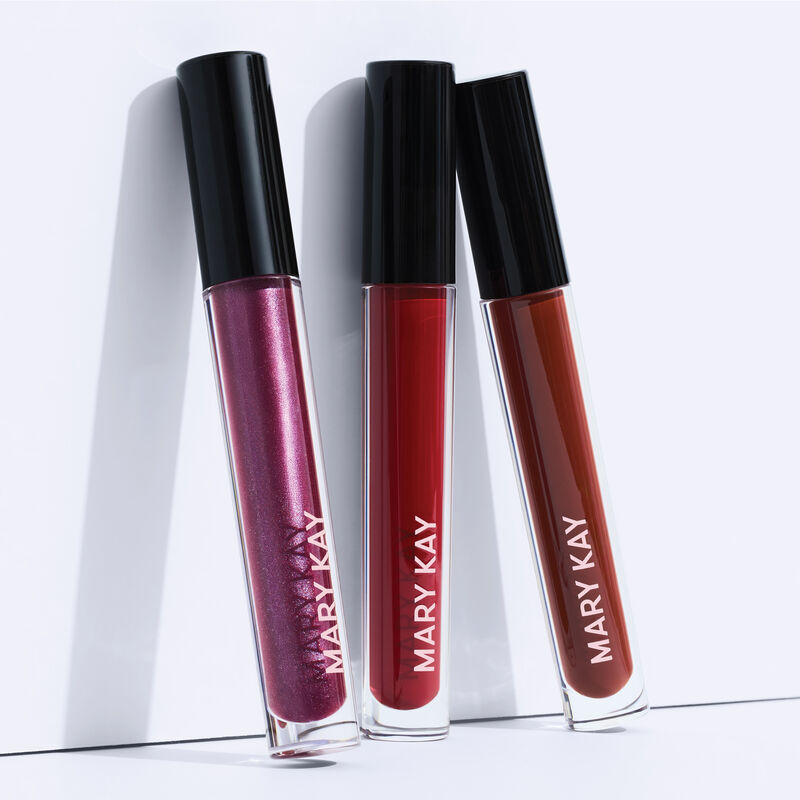 All three lip gloss shades, including Lilac Love, standing upright with caps on white surface.&nbsp; image number null