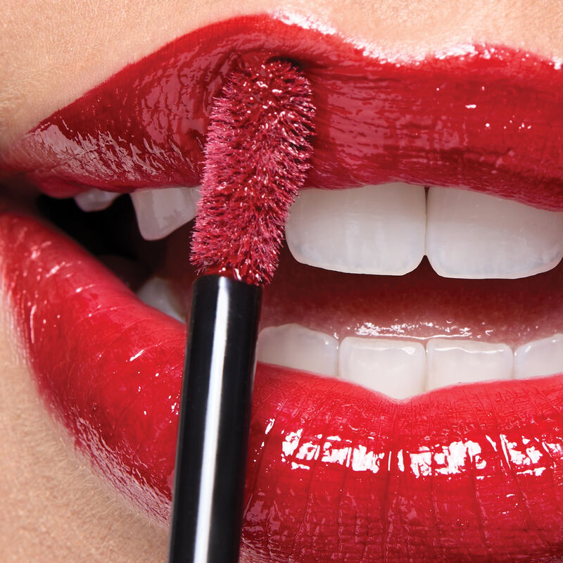 Macro of lips wearing Cherry Red with applicator. image number null