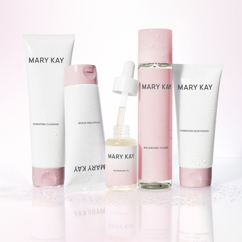 Mary Kay Skin Care products with open bottle of Mary Kay Nourishing Oil standing on reflective surface&nbsp;&nbsp;