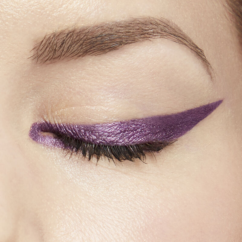 Close up of fair-skinned model wearing special-edition Mary Kay Waterproof Eyeliner in shade Amethyst in a sharp winged shape image number null