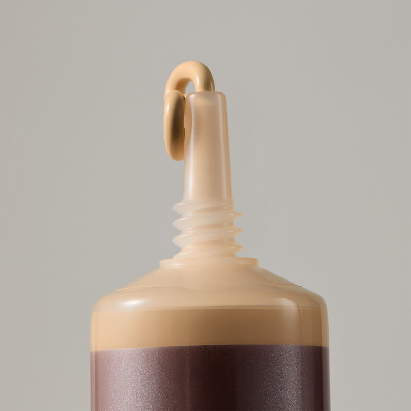 Macro view of TimeWise Matte 3D Foundation needle-nose applicator dispensing Light 6 shade