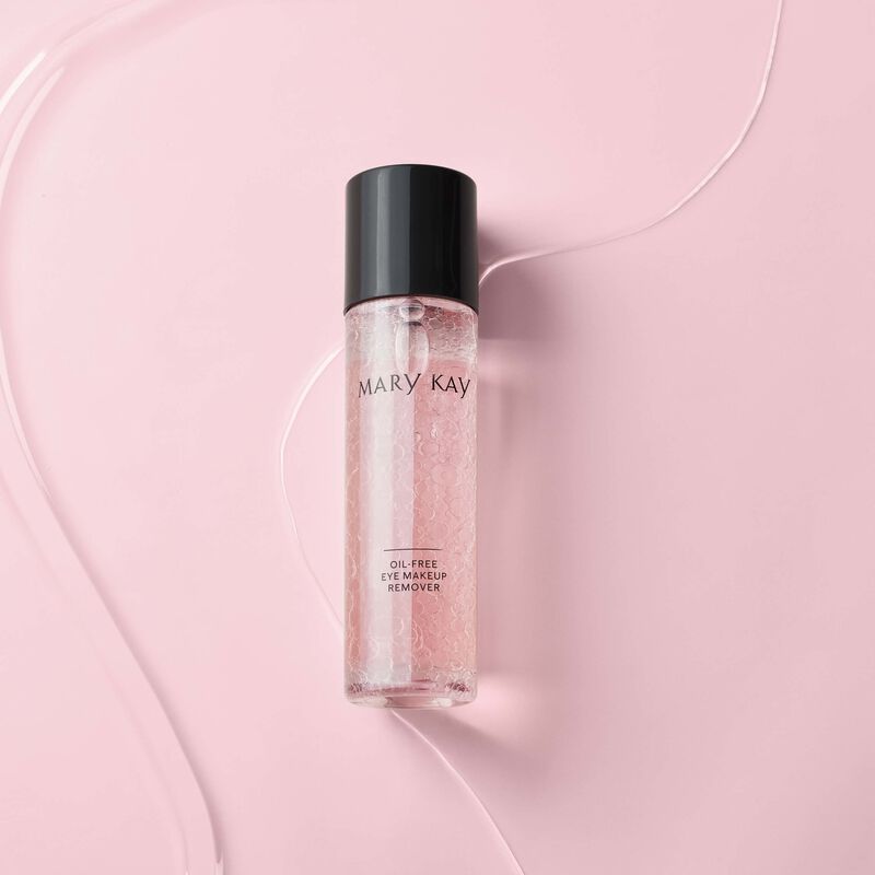 Bottle of Mary Kay Oil-Free Eye Makeup Remover against textured pink background