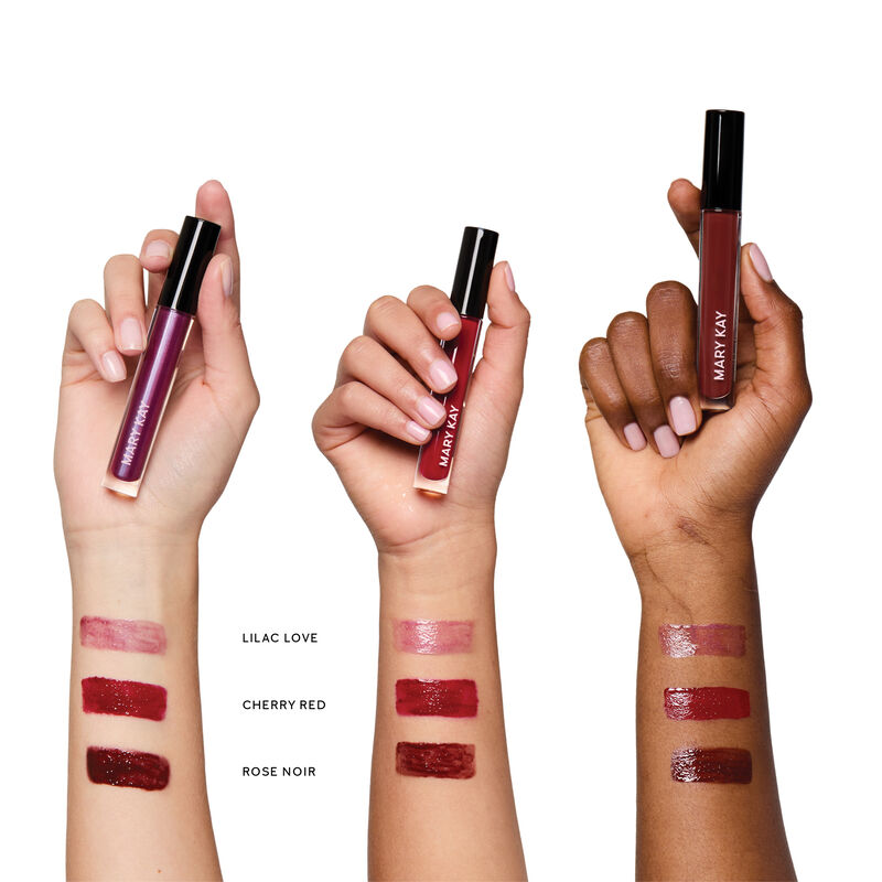 Swipes of Lilac Love, Cherry Red and Rose Noir lip gloss on wrists of light, medium and deep skin tones. image number null
