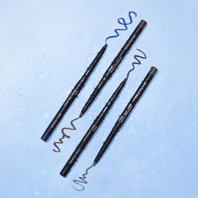 Uncapped Mary Kay Waterproof Eyeliner in Black, Steely, Blue and Brown covered in water  droplets against blue background