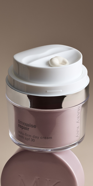 A close up of a woman's face with eye cream.
