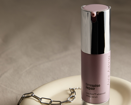 Advanced Lifting Serum standing in a dish with a silver bracelet and earrings.