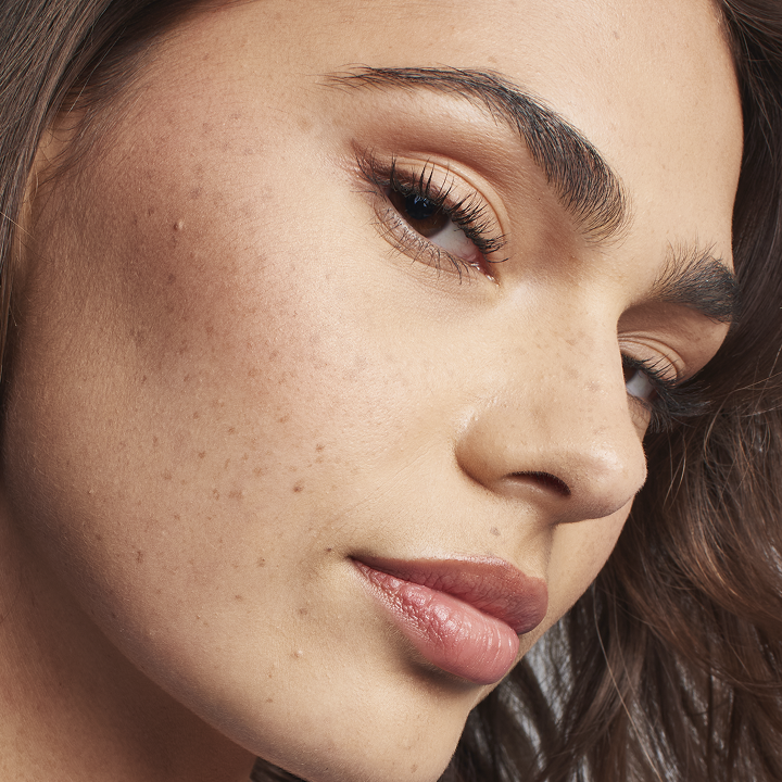 Medium skin tone model looking confidently at the camera while wearing Matte  foundation.