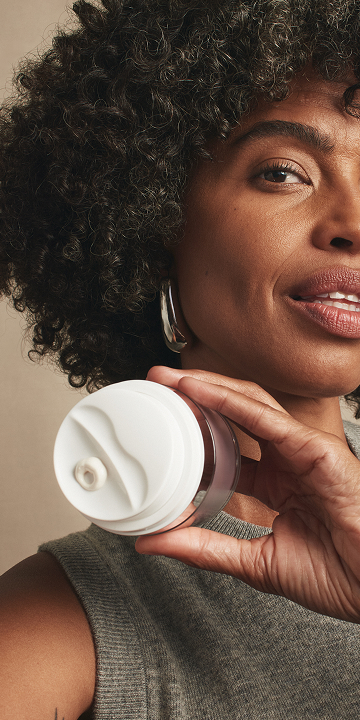 A close up of a woman with cleanser.