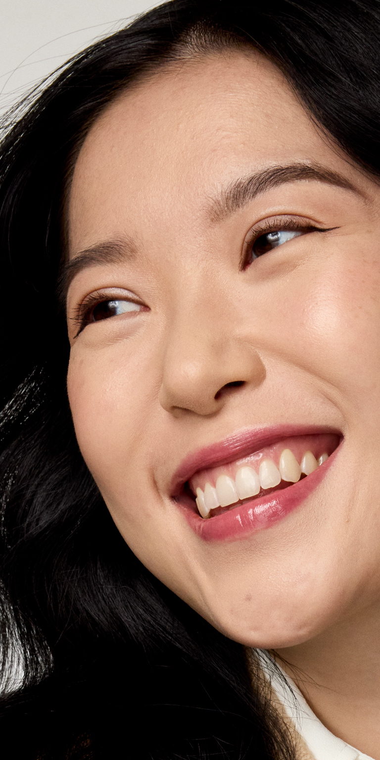 Profile view of woman smiling at the camera
