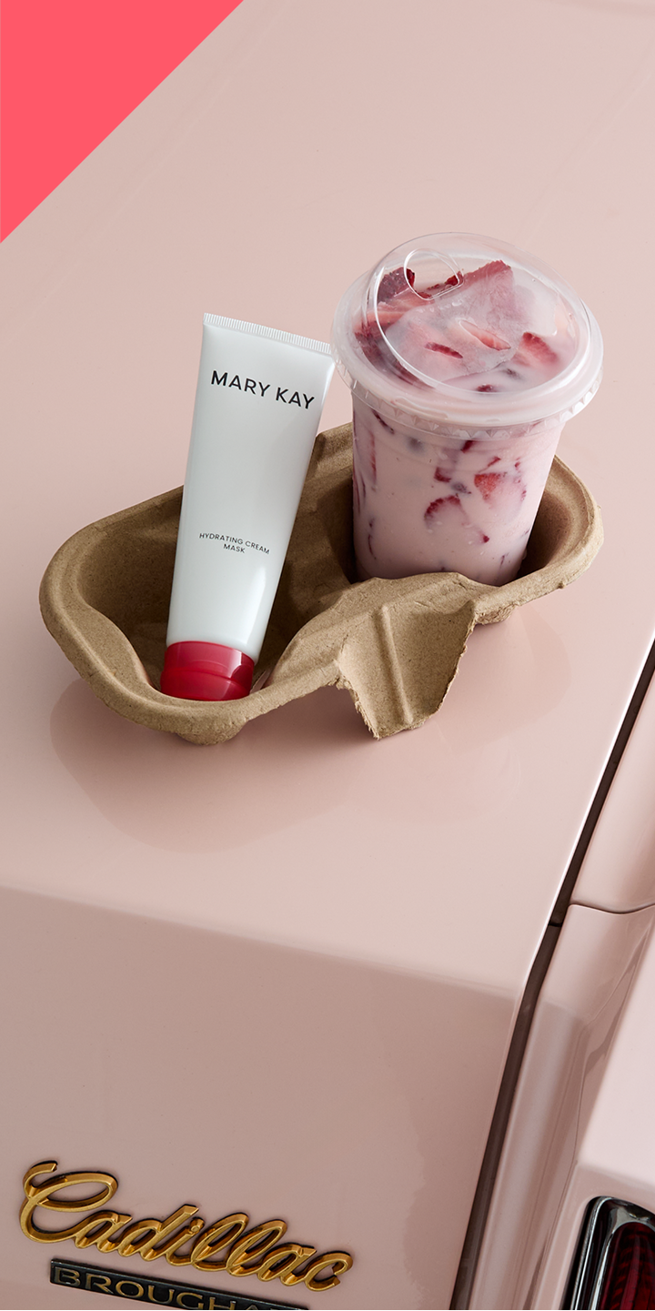 Mary Kay Hydrating Cream Mask in a cup holder with pink drink