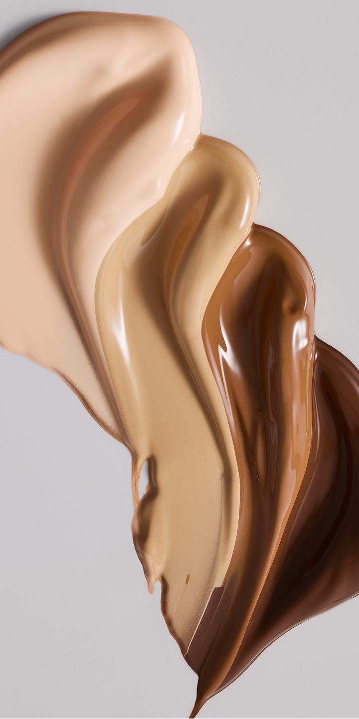 Aesthetic swipe of multiple Luminous foundation shades showing a radiant finish.