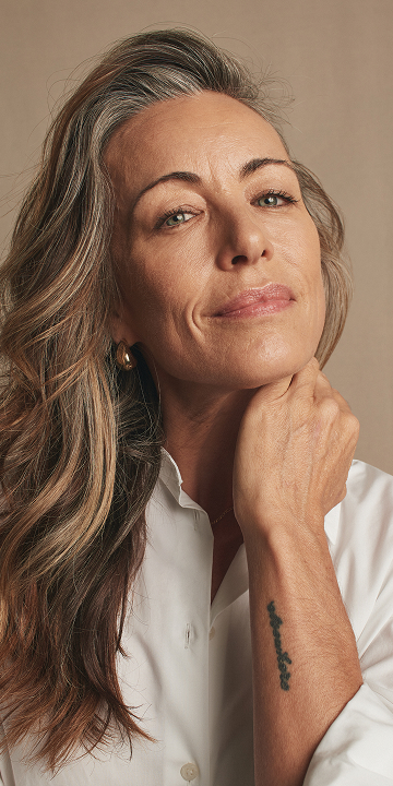 A close up of a woman with cleanser.