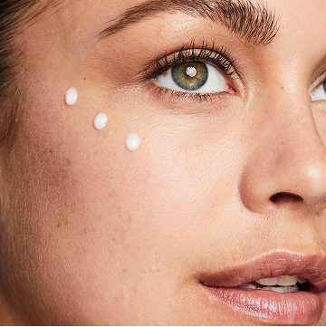 Woman with 3 dots of Mary Kay Vitamin C+E Serum on her cheek