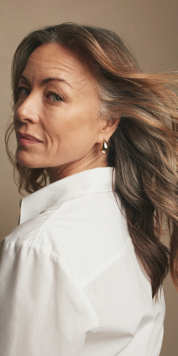 A close up of a woman with cleanser.