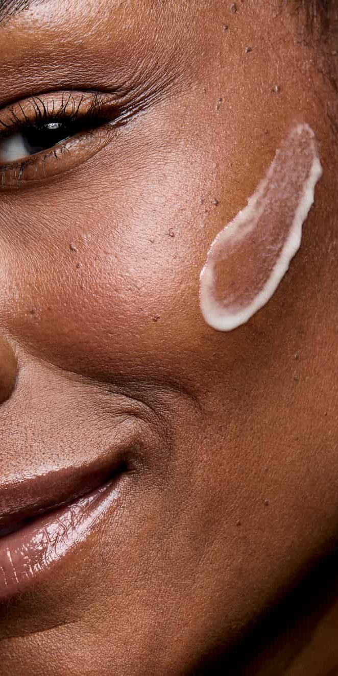 Woman with Mary Kay Clinical Solutions Retinol 0.3 cream on her cheek